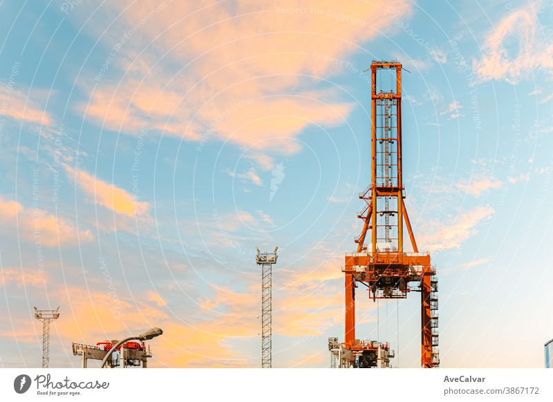 Horizon of some islands under a colorful sunset with a relaxing seascape lifting work industry site sunrise project silhouette development high industrial