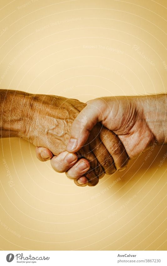 One young and white hand shaking one old and black hand deal business female success closeup handshake successful corporate human friendship job outside woman