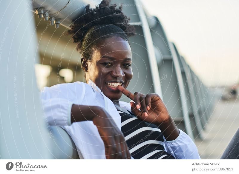 Smiling African American woman resting on street smile cheerful happy urban young enjoy positive content afro black female student african american ethnic