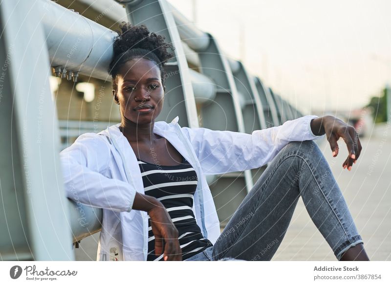 Smiling African American woman resting on street smile cheerful happy urban young enjoy positive content afro black female student african american ethnic