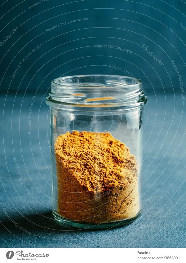 Garam masala in glass jar garam masala curry mix powder spices pakistani food dry blend vertical indian ingredient seasoning aroma organic yellow cuisine spicy