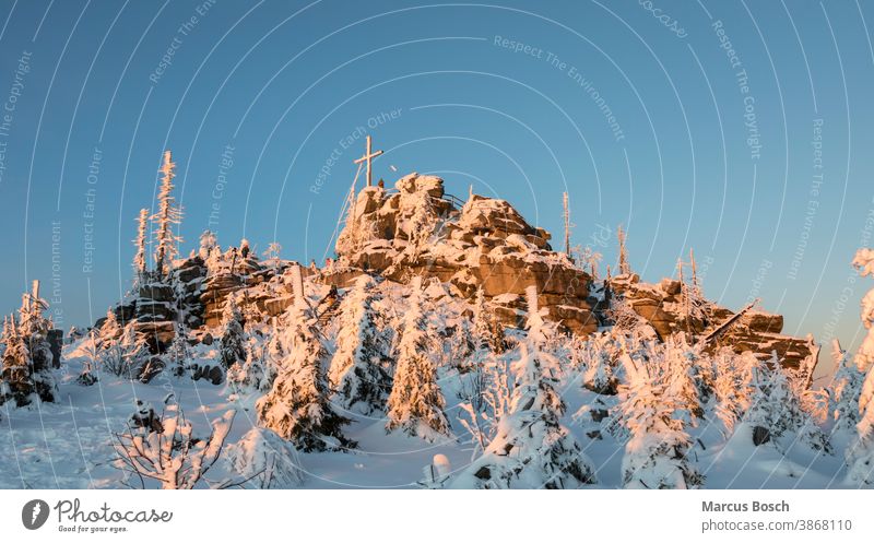 Three-seated rock in the evening light Triple chair Rock Frost granite rocks Highlands Evening sun evening mood Bavarian Forest Blue Ice Nature Snow snow