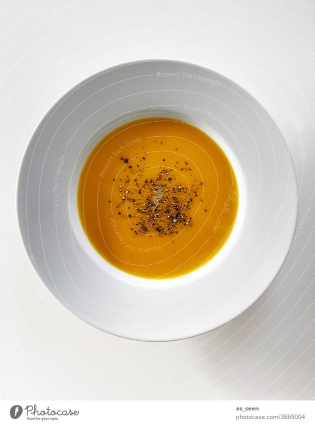 Pumpkin soup in minimalist Plate Orange Soup Autumn Food Vegetarian diet Colour photo Nutrition Healthy Deserted Lunch Studio shot Delicious Bowl pepper Black