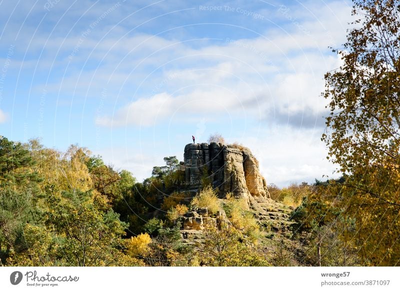 Male person stands on the Klus rock and looks down Klusberge Mountain Klusfelsen male person Tourist Landscape Adventure Trip Autumn sandstone rocks Outdoors