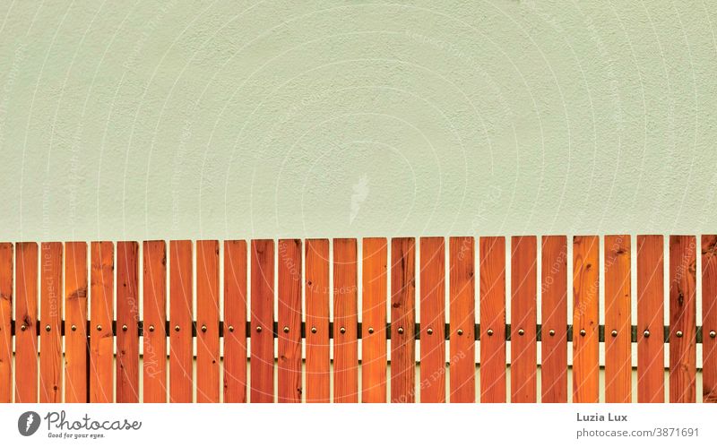 Fence, brown and orange in front of a house wall in light olive, suburban aesthetics Pre-cooking Wall (building) Brown Orange Olive Facade Deserted