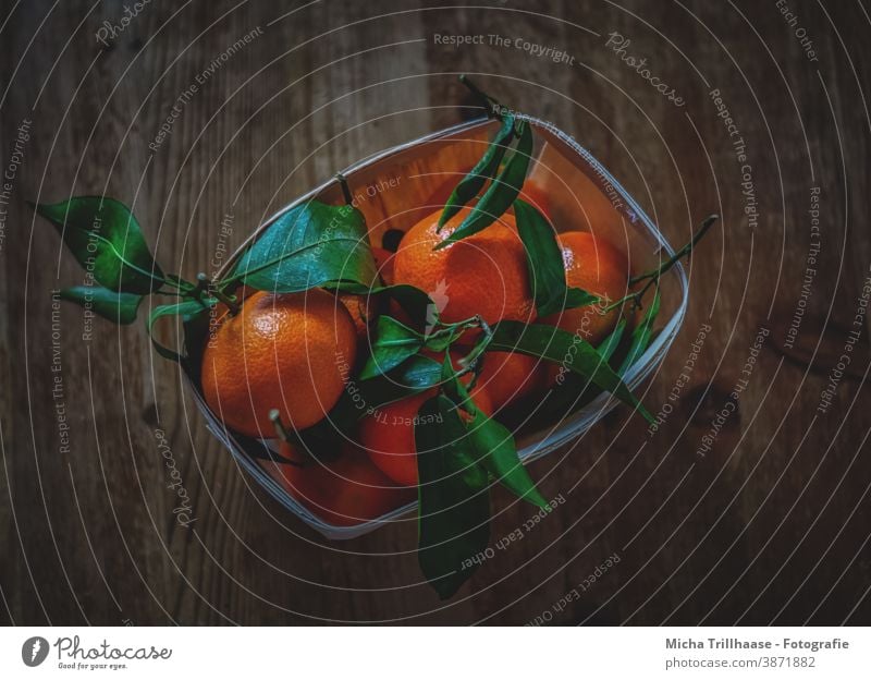 Orange basket on the wooden table oranges mandarins Clementines fruits Tropical fruits shell leaves stems Stalk Fruit basket Table Wood Wooden table Tabletop