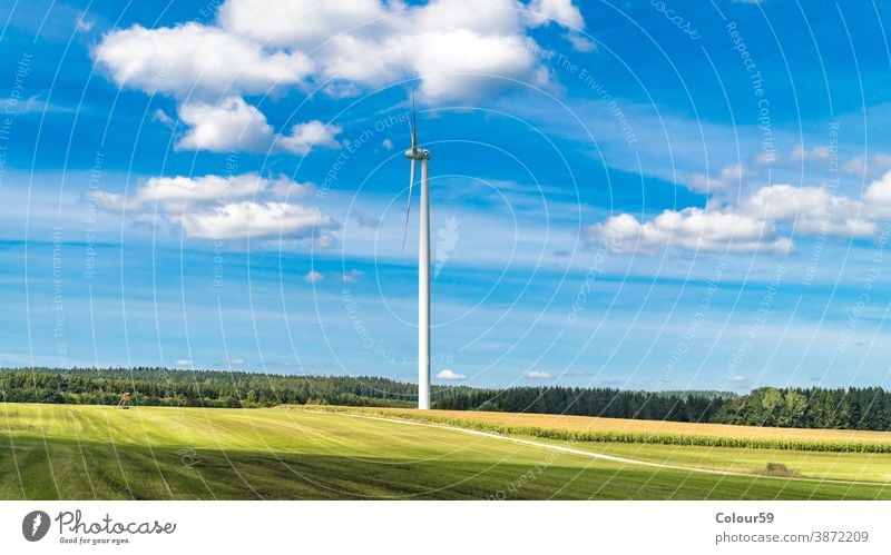 Wind turbine surrounded by agricultural land energy windmill renewable detail generator alternative electricity technology blade farm environmental