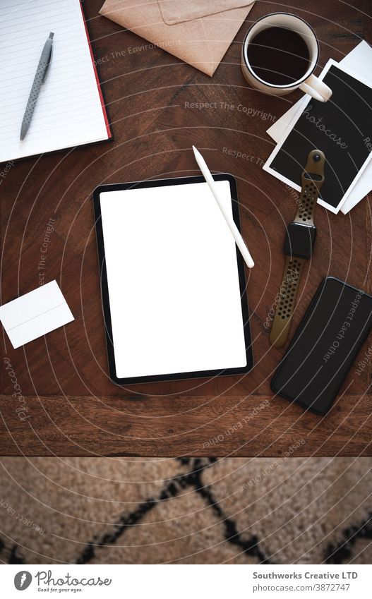 Above view of tablet computer on wooden table. technology business smart phone digital tablet blank watch above screen white flat lay background mock up mockup