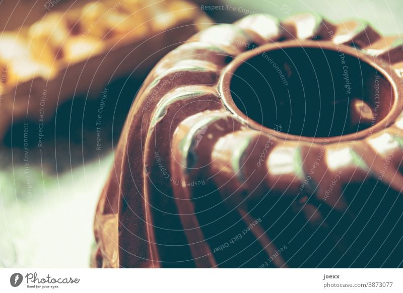 Brown ring cake pan, shallow depth of field Baking shape Cake tin Baking tin Gugelhopf Bundt pan Close-up Colour photo bake email Old Eggs cardboard