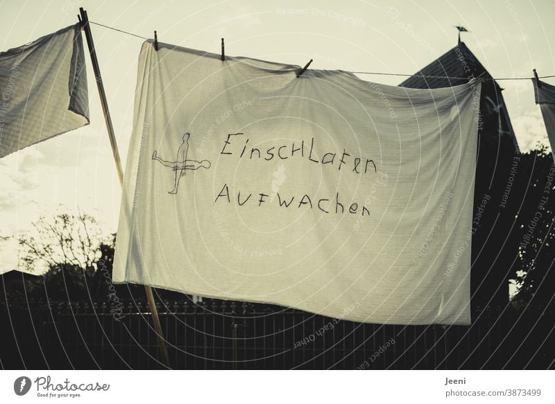 "TO WAKE UP IN AWAKE" on a bed sheet by the clothesline fall asleep Wake up Night Sleep Bed Alert Dream tired Fatigue Arise Oversleep Lie Bedroom Relaxation