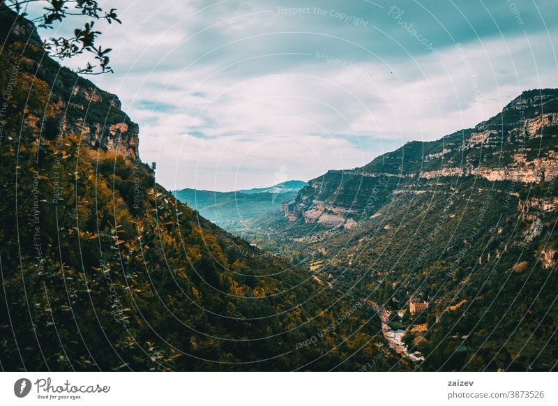 Landscape with views of green fields and majestic mountains Cingles de Bertí Riscos de Berti sant miquel del fai landscape trees grove nature vegetation natural