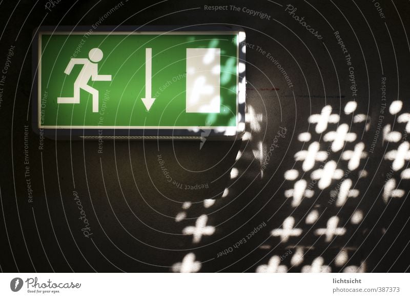 Down to the light Wall (barrier) Wall (building) Stairs Sign Signs and labeling Signage Warning sign Arrow Green Black White Downward Road marking Direction