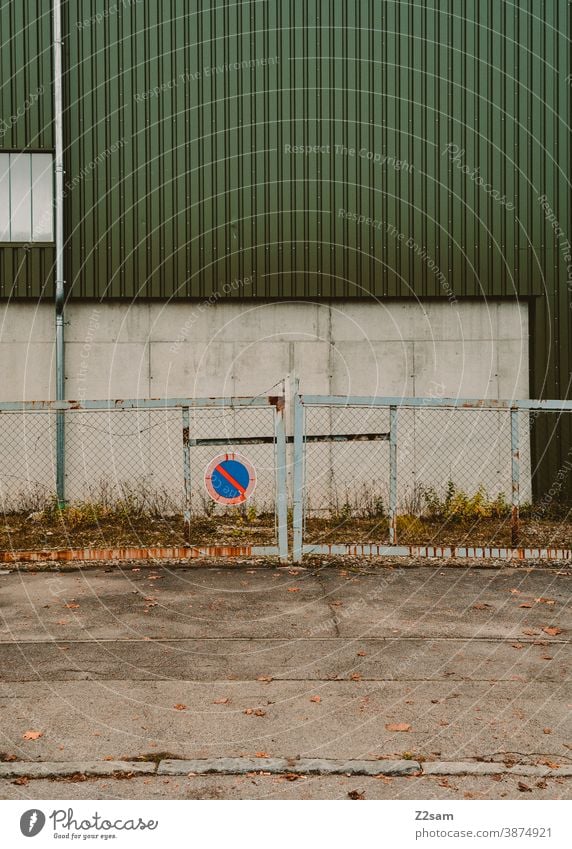 Overgrown driveway in an industrial area Industry Architecture Industrial hall Industrial area Goal Hall Factory Factory hall lines minimalism Concrete Lonely