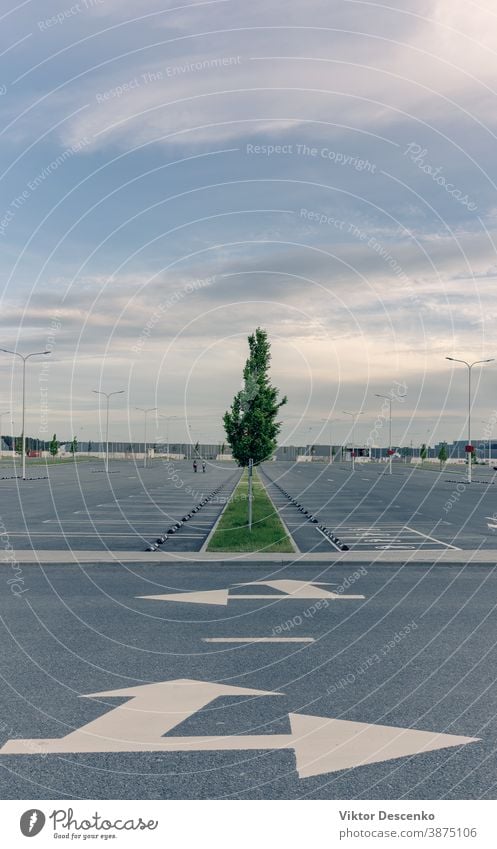 Empty parking at the mall in the evening central cityscape road sky lamp industrial pattern consumerism entrance dusk outlet outside space architecture centre