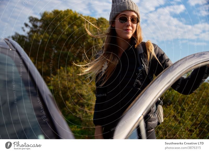 Young Woman With Backpack Getting Out Of Car Before Setting Off For Hike In Countryside hiking hike woman young women walk walking trek active backpack holiday