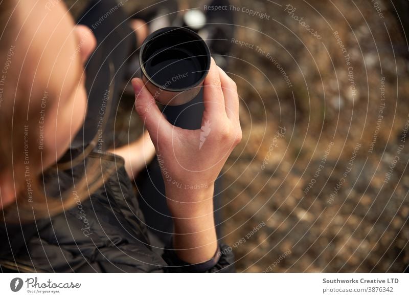 Close Up Of Woman Taking A Break From Countryside Hike And Drinking Coffee From Flask coffee walking woman young women hike hiking trek camping taking a break