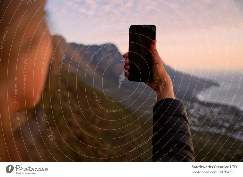 Close Up Of Woman Hiking Along Coastal Path Posing For Social Media Selfie On Mobile Phone taking photo taking picture woman young women hike hiking walk