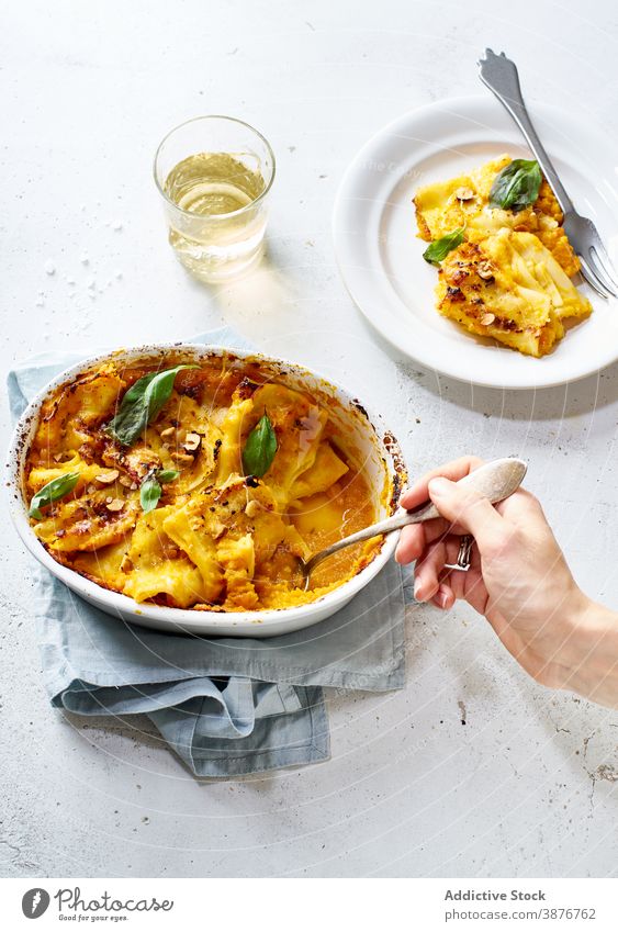 Crop woman eating delicious baked squash dish spoon healthy food vegetarian female tasty homemade meal cuisine table culinary recipe yummy nutrition plate