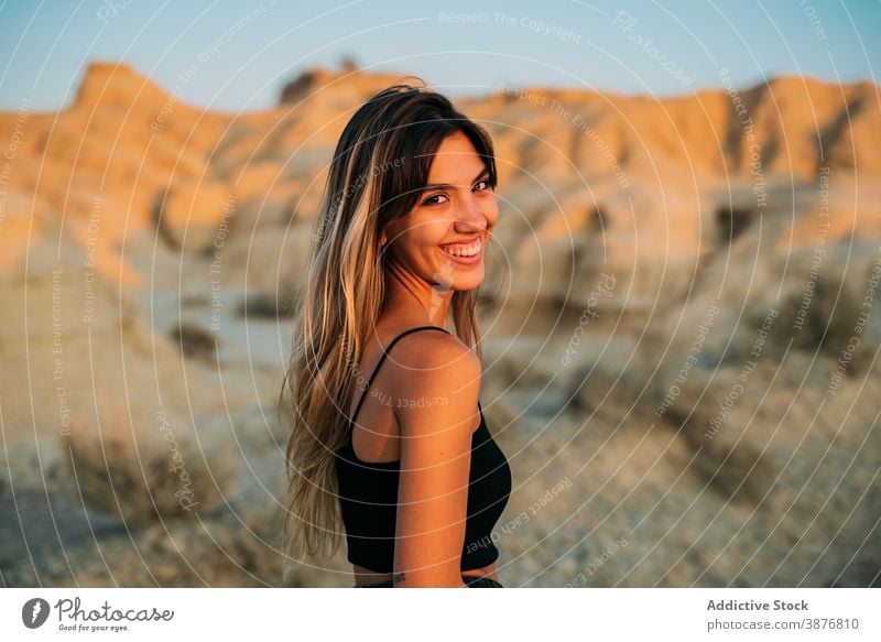 Delighted woman enjoying summer vacation in desert bardenas reales traveler sunset tourism valley dry female spain sunlight nature happy young carefree smile