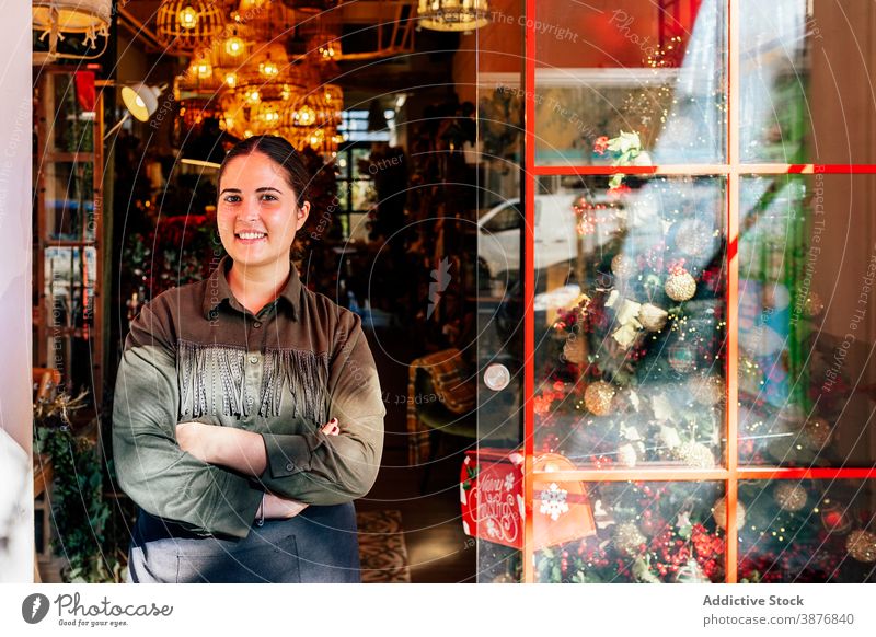 Facade of shop with christmas decorations woman holiday window winter store festive illumination xmas street city outside celebration ornaments beautiful door