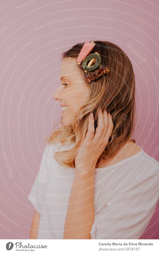 Blonde Woman with Clips in her hair, modern hair pins, pink background accessories blonde clip close-up copy space editorial fashion fashion photography