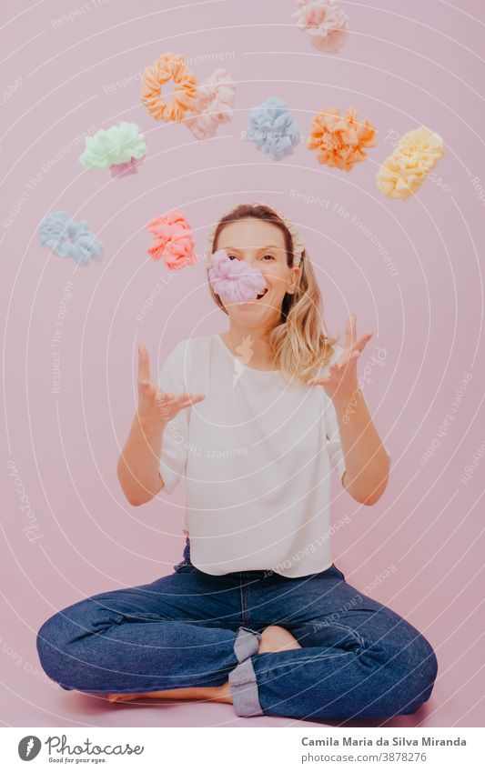 Woman with blond hair. Studio portrait of stylish woman throwing out scrunchies. background beautiful beauty blonde caucasian celebration expression fashion