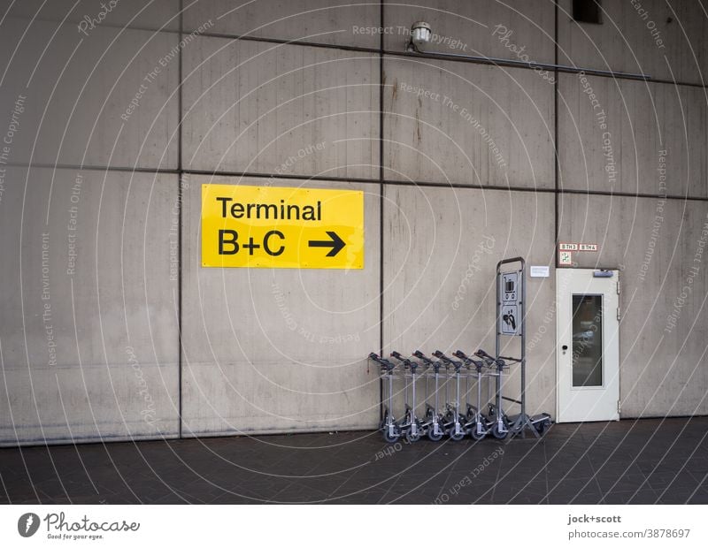 luggage trolleys, Terminal A, Tegel Airport direction arrow Wall (building) Road marking Cladding Signs and labeling door Orientation Symmetry Colorless