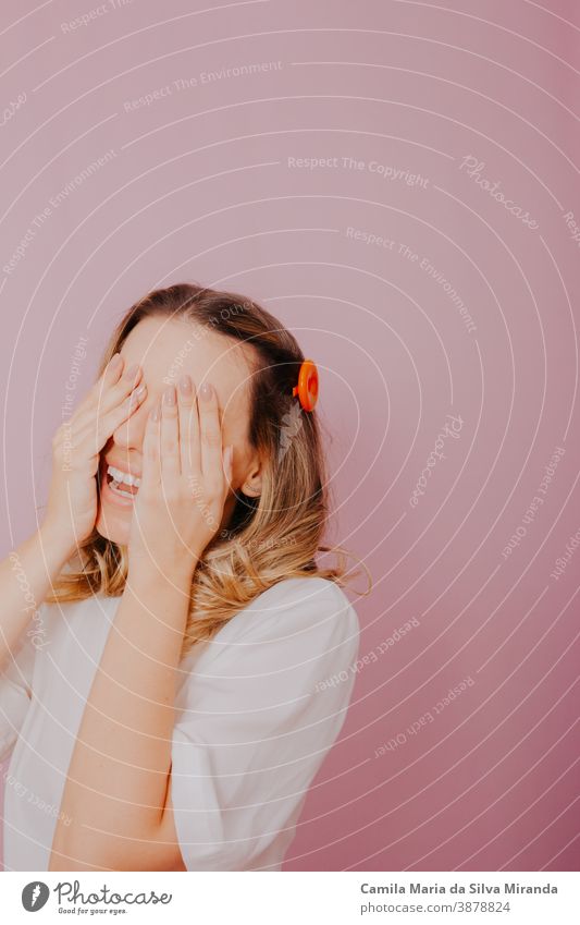 Blonde woman closed her eyes with her hands and waiting for surprise. amazed background beautiful blond hair blonde closed eyes emotional emotions expect