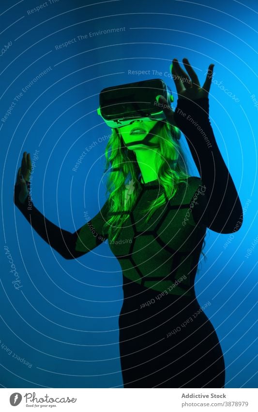 Anonymous young woman having VR experience vr headset technology device virtual reality modern innovation entertainment video futuristic simulation hi-tech