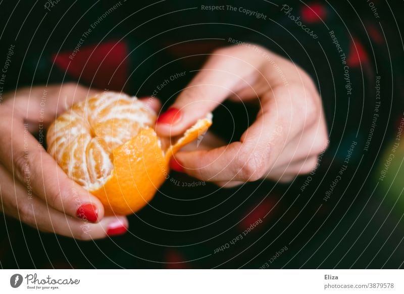 A woman's hands peel a tangerine Tangerine Nail polish Woman fruit cute Fresh Delicious vitamin V Orange clementine citrus fruit red nail polish Fruit Winter