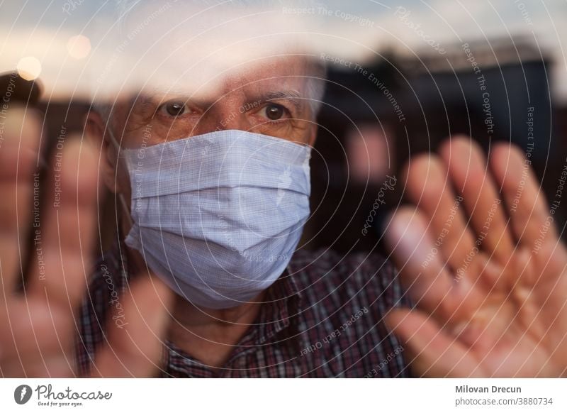 Elderly caucasian man wearing hand made protective face mask anxious care contagious corona coronavirus covid-19 crisis deadly depressed depression disease