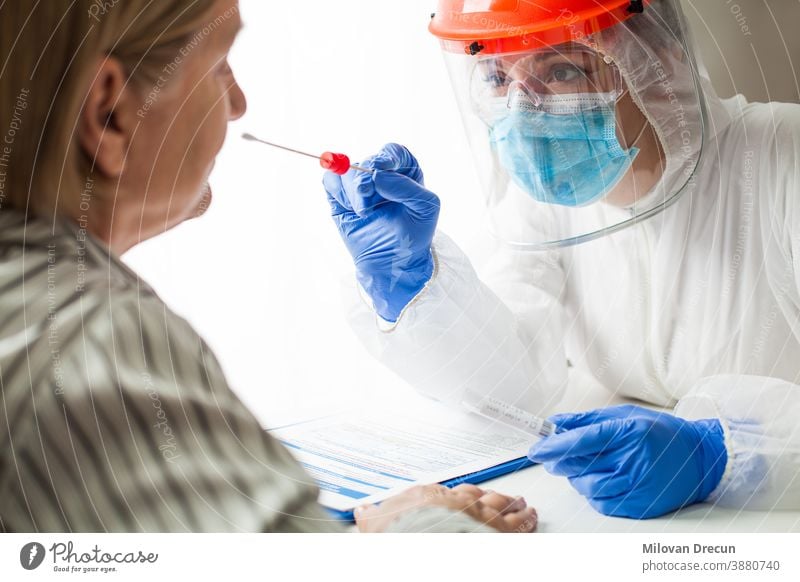 Physician wearing personal protective equipment performing a Coronavirus COVID-19 PCR test analysis biotechnician care clinic contamination corona coronavirus