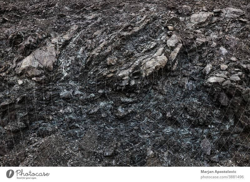 Close-up of a dark gray rock abstract antique background basalt black burial close-up closeup compressed crack crust design detail dirt earth effect erosion