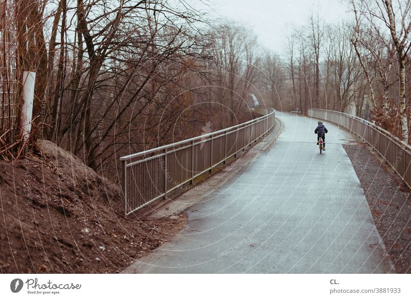 child on bicycle Bicycle Cycling Child Lanes & trails Winter Gloomy Traffic infrastructure Driving Mobility Cycle path Movement