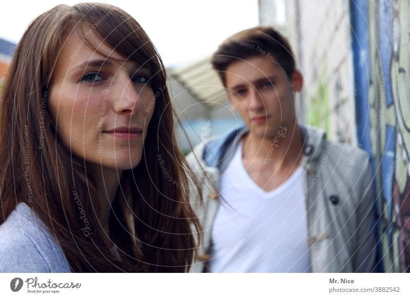 in the foreground are Brothers and sisters 2 Couple Hip & trendy Self-confident Long-haired Authentic Style Lifestyle Man Woman Fashion Easygoing