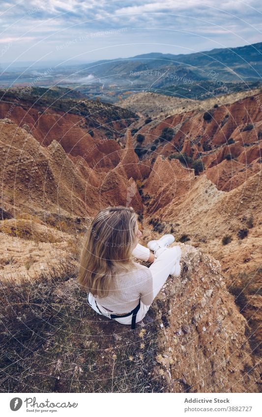 Travelling woman observing rocky mountains travel explore observe contemplate wild nature sandstone female explorer alone adventure journey tourism wanderlust