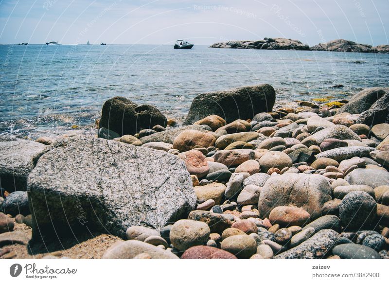 Close-up of some pebbles on the seashore taken at ground level costa brava calella de palafrugell palamós landscape views water mediterranean catalonia seascape