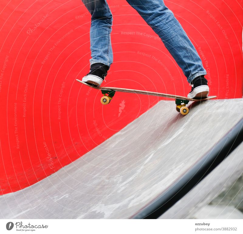 Skater playing skateboard in the park with red wall background Sports Wheel youthful Extreme Ice skate Black Board Skateboard skateboarder Skateboarding