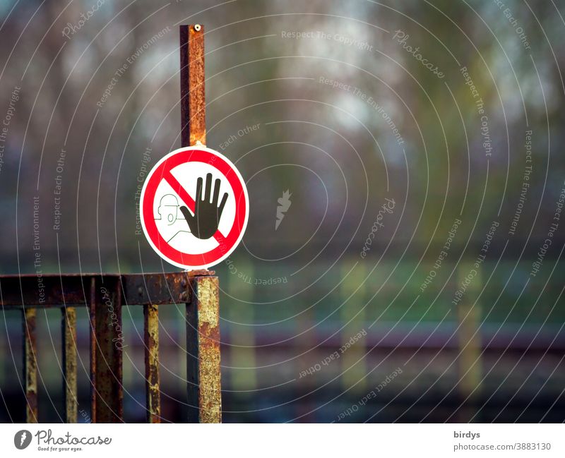 No trespassing, prohibition sign on a rusty railing. Passage forbidden. Pictogram. shallow depth of field Prohibition sign interdiction pictogram transit ban