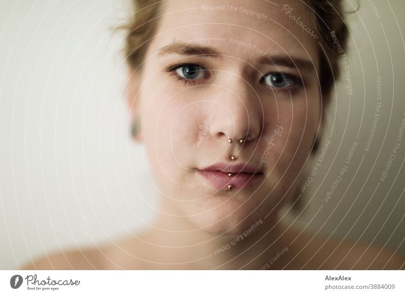 Close portrait of a young woman with dreadlocks and piercings Woman Dirty Blonde tattooing Jewellery Piercing earring Concealed Direct Nahe Skin Expression