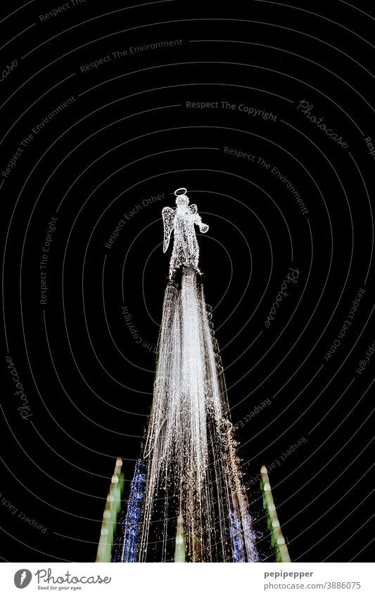 Largest Christmas tree in Dortmund photographed with zoom effect Night bokeh Detail blurred Exterior shot Portrait format no persons Long exposure