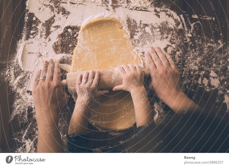 Mother and son rolling out cookie dough. kid woman rolling pin cookies roll out flour Advent Arms Christmas Family Food Fun Generations Hands Holidays Home Joy