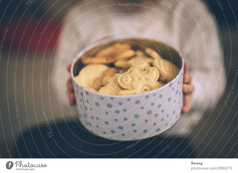 Young boy holding cookie jar. child kid cookies box Advent Aperture Christmas Depth of Field Enjoyer Enjoyment Family Food Fun Generation Generations Hands