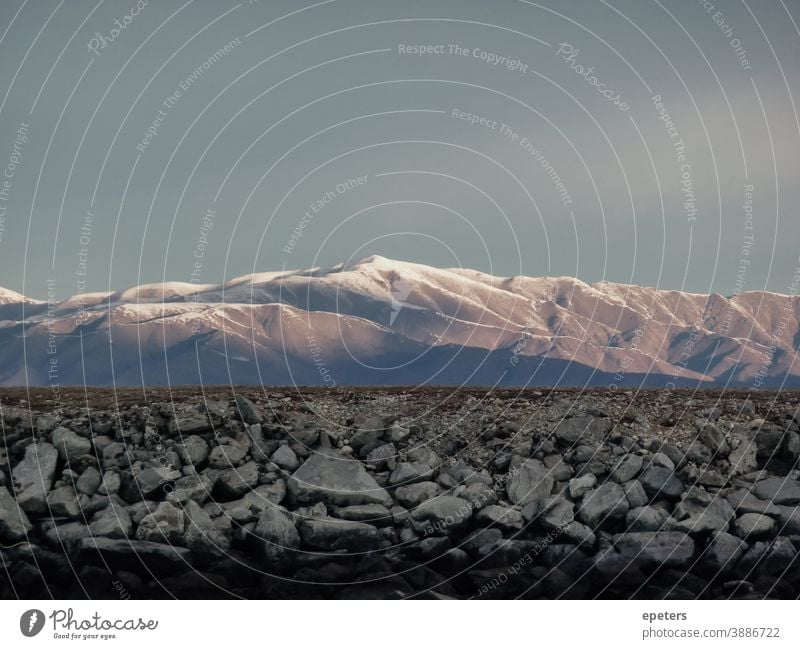 Landscape with mountains in New Zealand Canterbury Southern Alps Channel Sunset Moody atmospheric stones unusual copy space pile