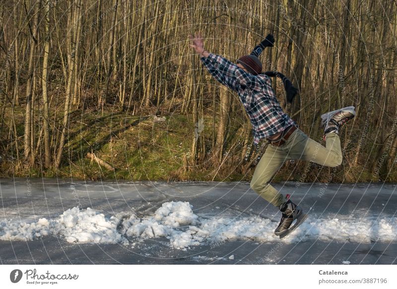 Off to the weekend, young man skating Young man ice skating Jump skates fun Winter Scarf Ice Cold and frost swift Joy frozen trees Lake Athletic Gray Green Blue