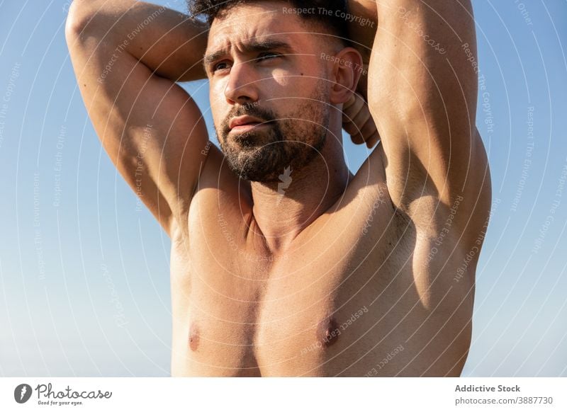 Muscular man with naked torso standing in nature shirtless sportsman bodybuilder muscular strong handsome determine athlete male fit beard wellness wellbeing