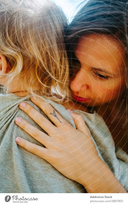 Delighted woman cuddling child in forest mother kid hippie together little carefree freedom hipster adorable fun summer woods bonding enjoy motherhood weekend