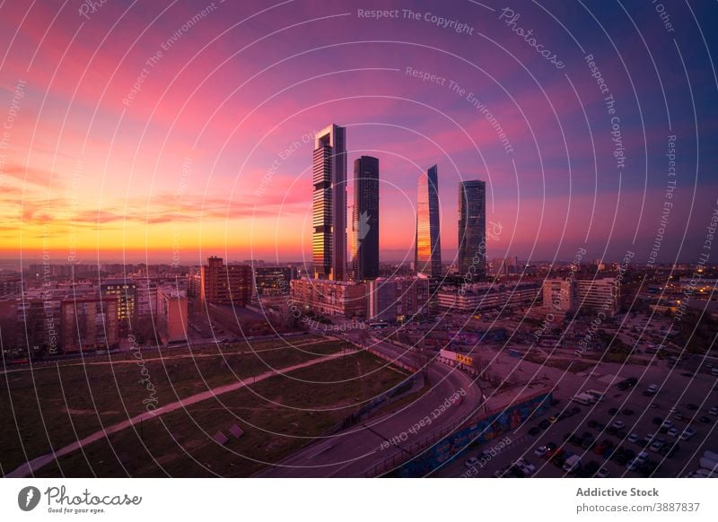 Contemporary megapolis district in sunset skyscraper cuatro torres business area evening bright pink sundown cityscape skyline metropolis madrid spain modern