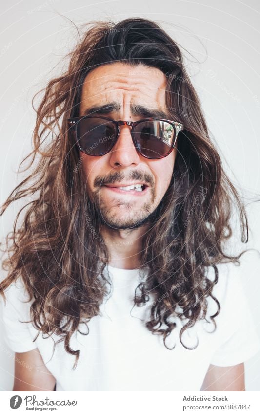 Hipster man with funny surprised face looking at camera amazed hipster long hair beard sunglasses human face expressive selfie young male grimace unbelievable