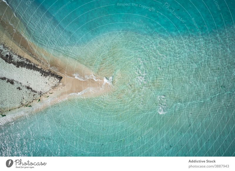 Small island in blue sea ocean water coastline nature landscape uninhabited seascape sand picturesque small turquoise beach shore seashore travel tourism